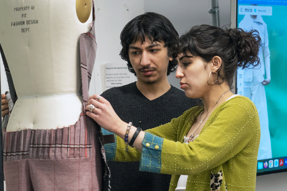 FIT fashion design students working with dress form