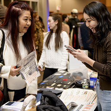 people talking and looking at the display of wares at the vendor tables