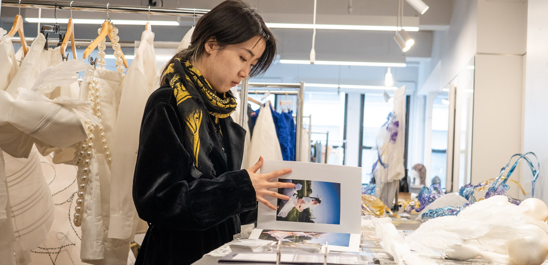 Fashion Design MFA student looking through book