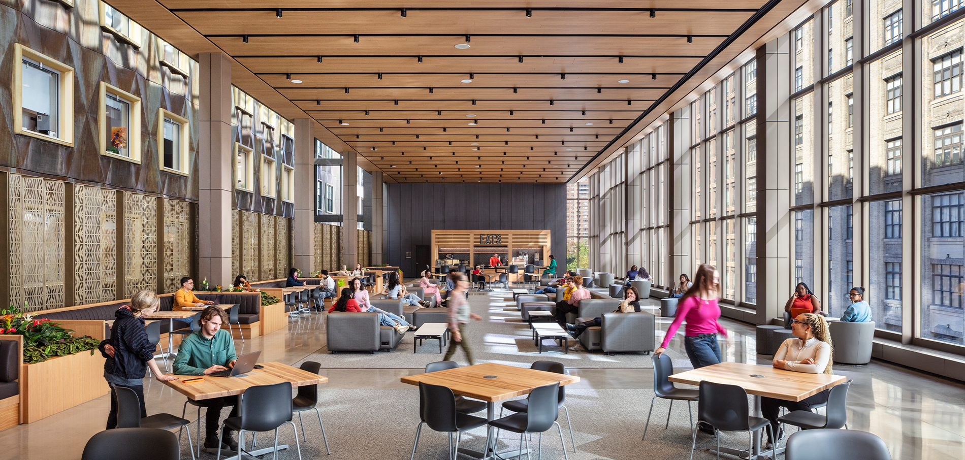 People sitting in the Student Commons area of the Joyce F. Brown Academic Building