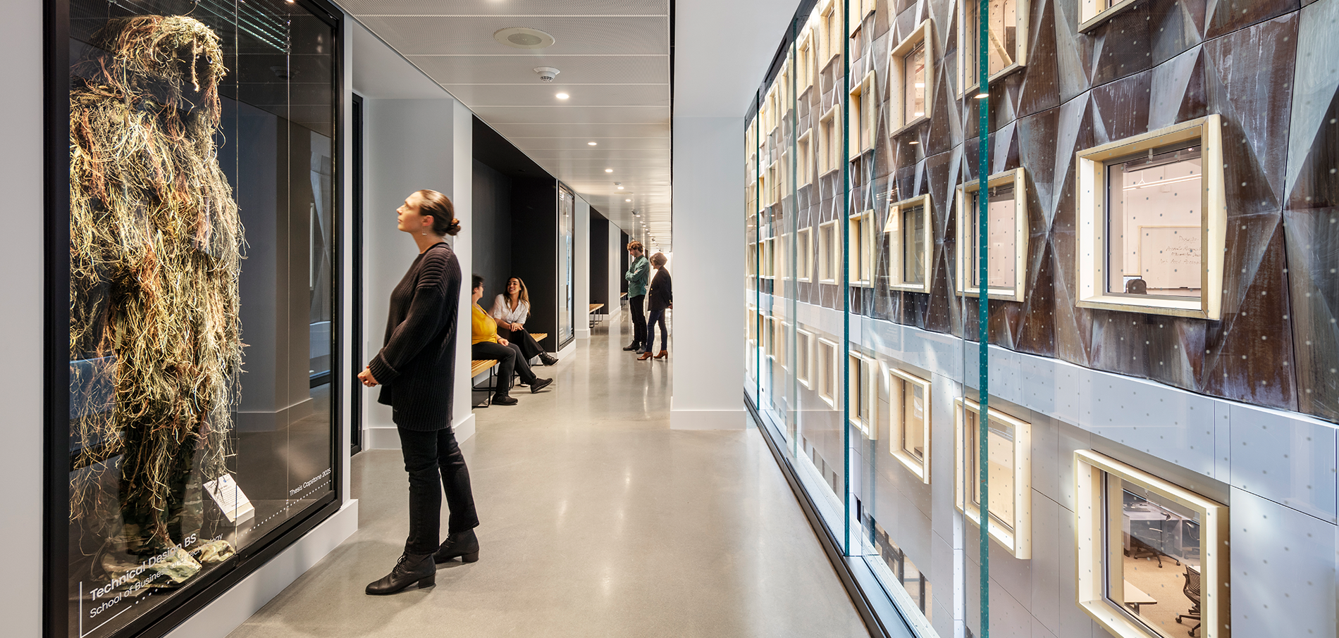 person looking at vitrines in the Joyce F. Brown Academic Building