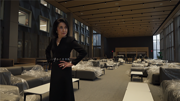 Dr. Brown with her hands on her hips in the new student commons area
