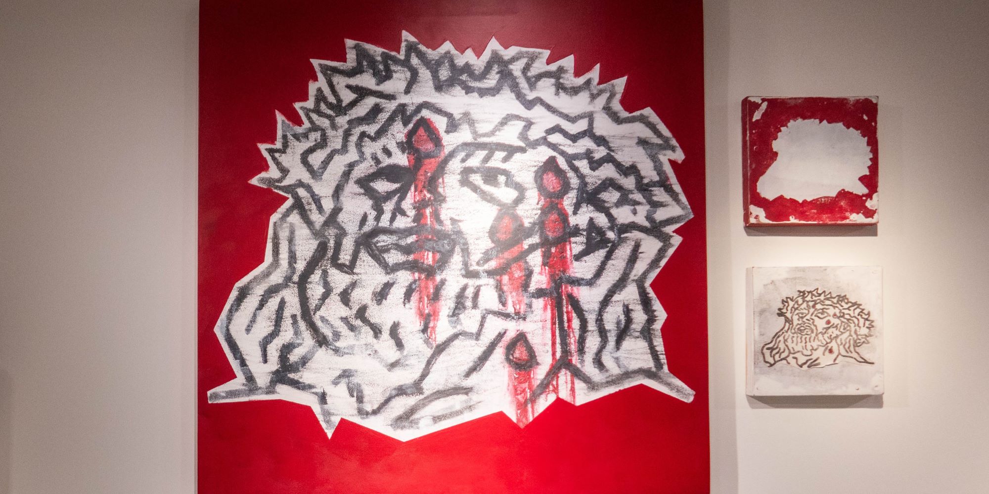 advertising and design. a group of three works - two small canvas with different focus on the elements of design: one of black line drawing, one of red canvas with a large irregular shape at the center, and three ideas combined in the largest piece that combines the two smaller ideas