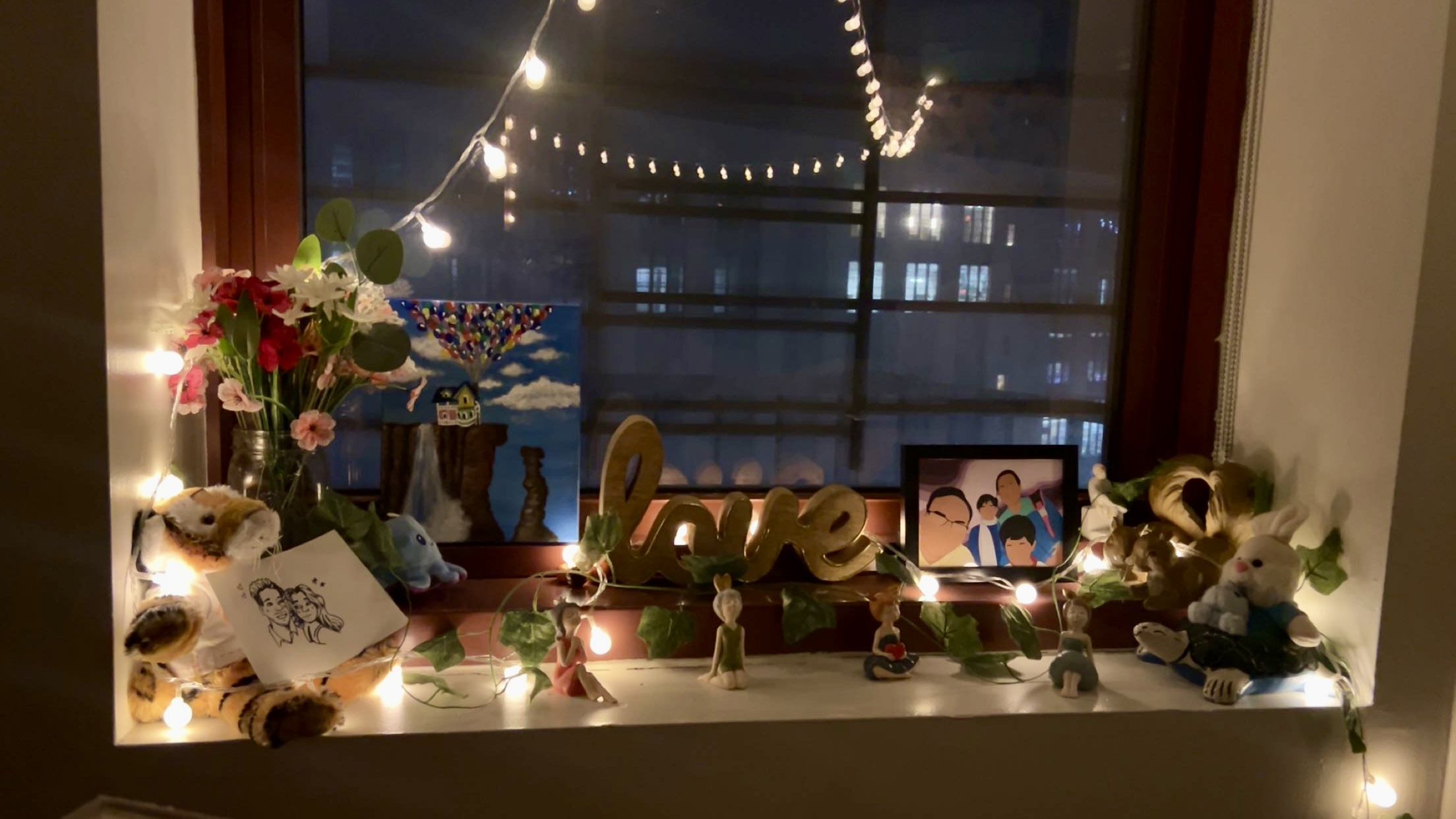 Looking out of window at night with decorations on windowsill