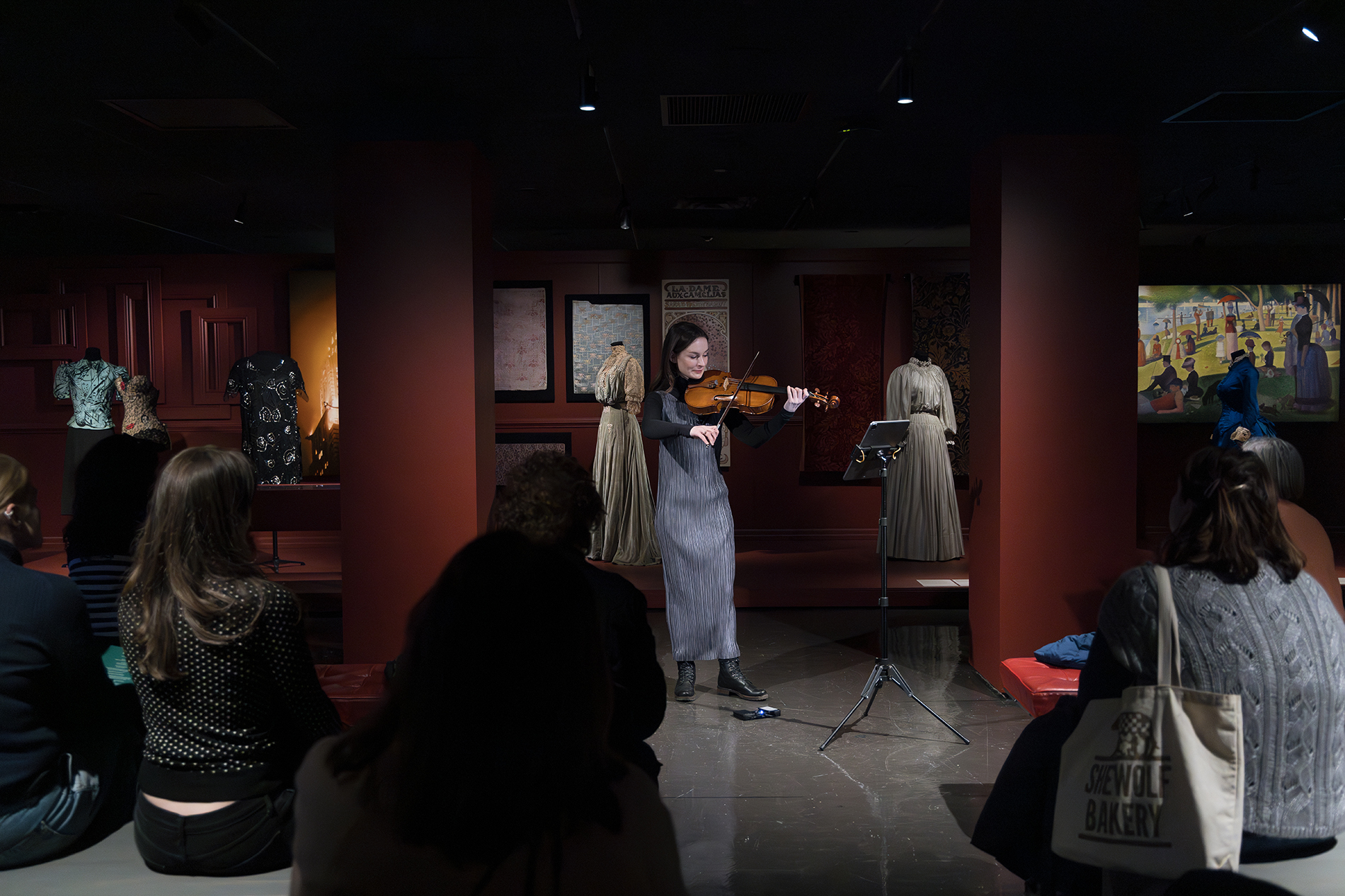 Violist Leah Ferguson playing in the Art X Fashion gallery for an audience