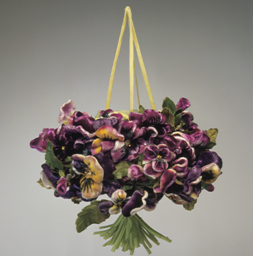 drawstring pouch covered with violet, yellow, and white velvet pansy flowers, joined with green stems at bottom point