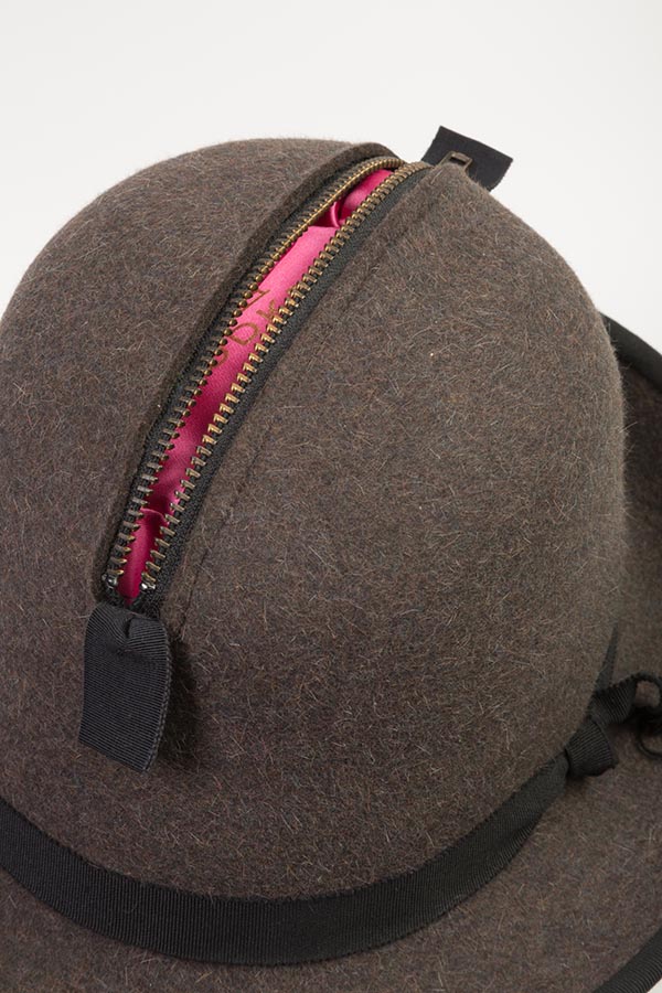 close up image of hat with zipper opening at the top