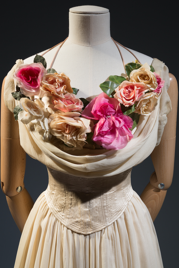 view of beige corset bodice with draped neckline with pink and peach silk flowers
