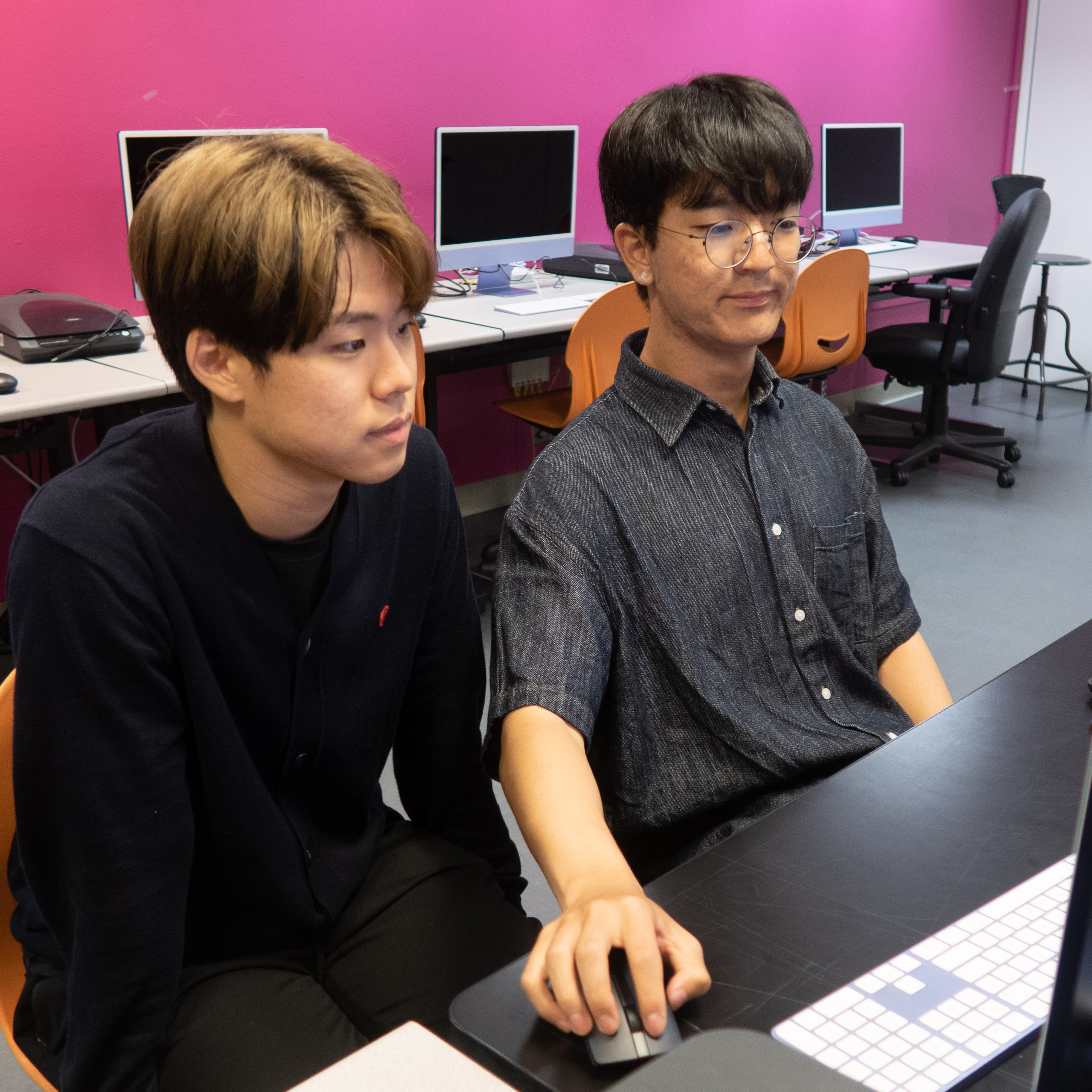 two students working on a computer