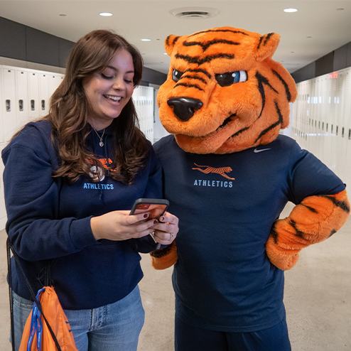 FIT student looking at her phone with Stitch