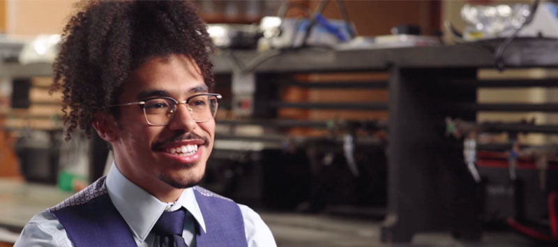 Student smiling sitting on a couch