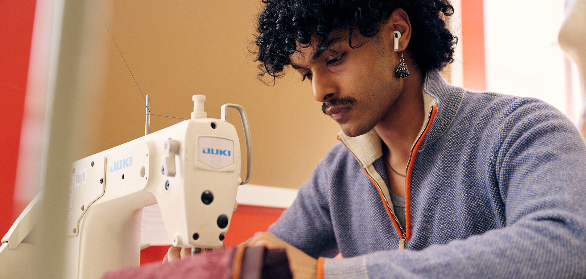 FIT student sewing in Menswear program