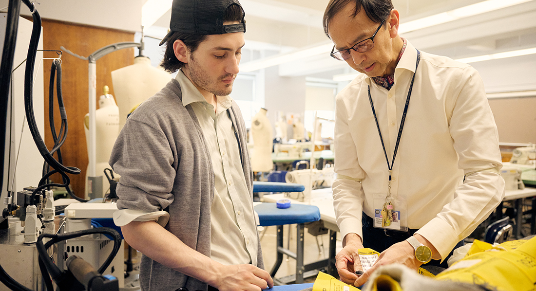 FIT student and professor working on garment in Menswear program