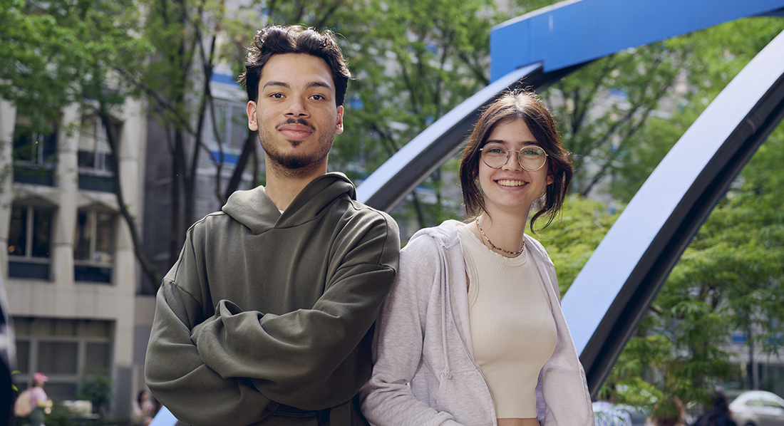 A guy and a girl smiling outside of Feldman Building