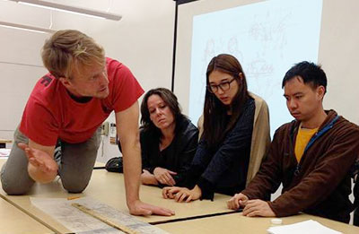 students with faculty member in classroom