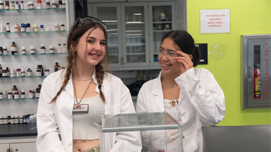 Two female students in lab coats