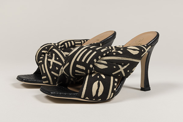 pair of black and tan batik cotton high heel sandals