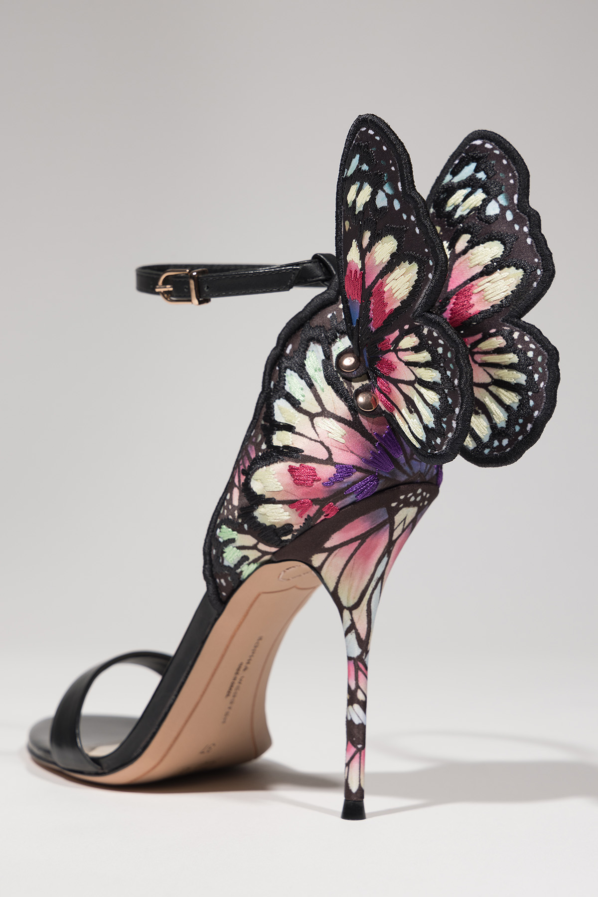 high heel with strap and butterfly attached at back