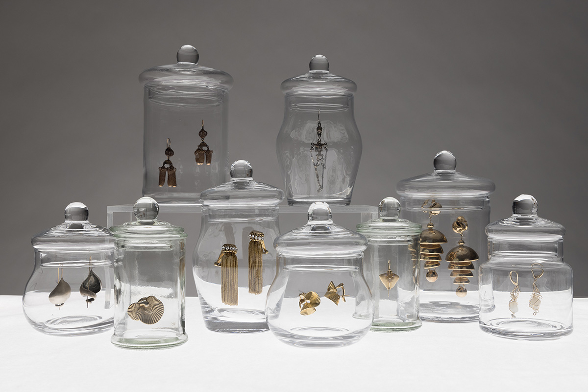 earrings placed in clear glass jars