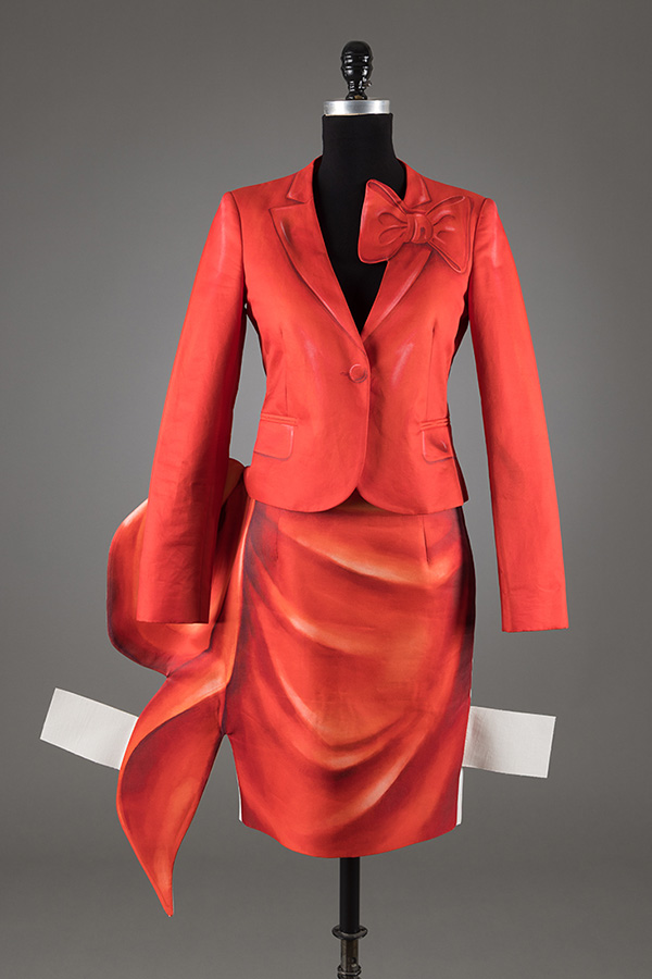 red jacket and skirt red jacket and skirt with print of trompe l'oeil draping and protruding white tabs like paper dolls
