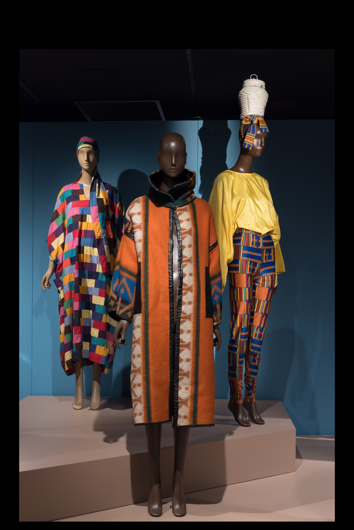 three mannequins in colorful ensembles