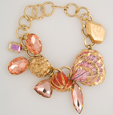 costume jewelry necklace of large goldtone rings with pastel facets stones and faux shells