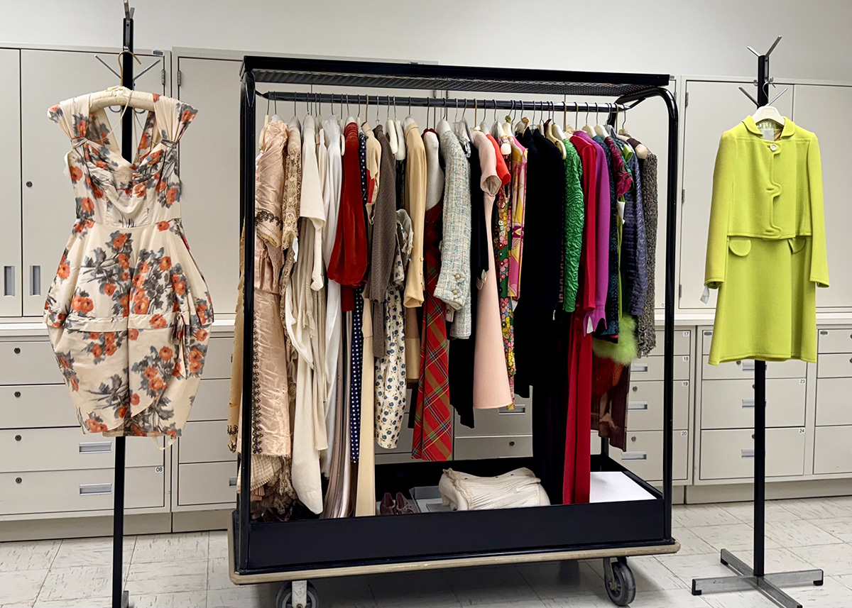 a clothing rack with various clothes in a classroom