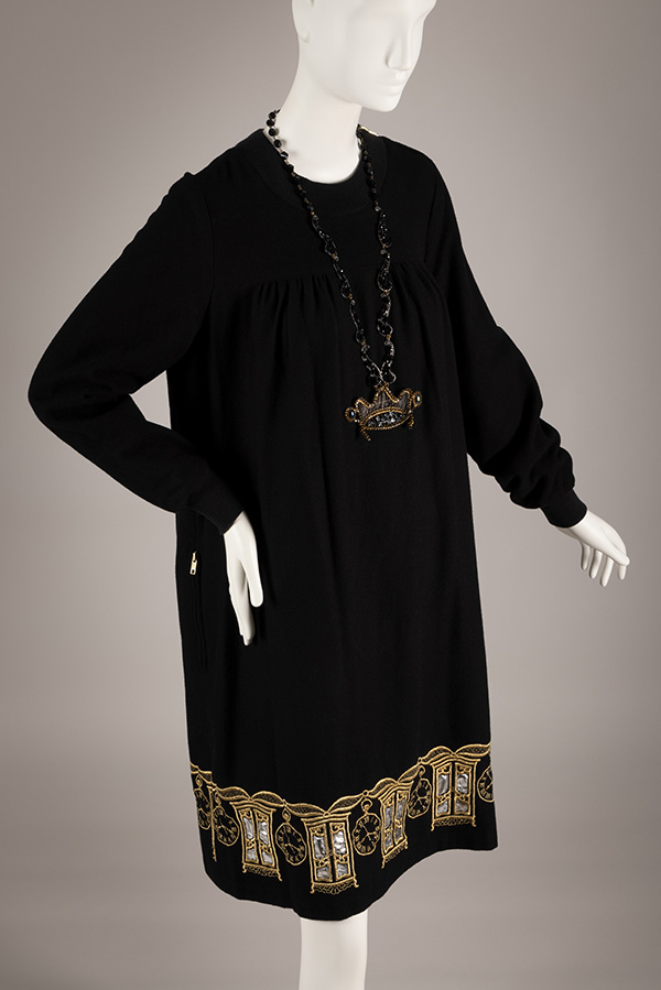 long sleeve knee length dress with antique clock and wardrobe motif at hem, styled with crown necklace