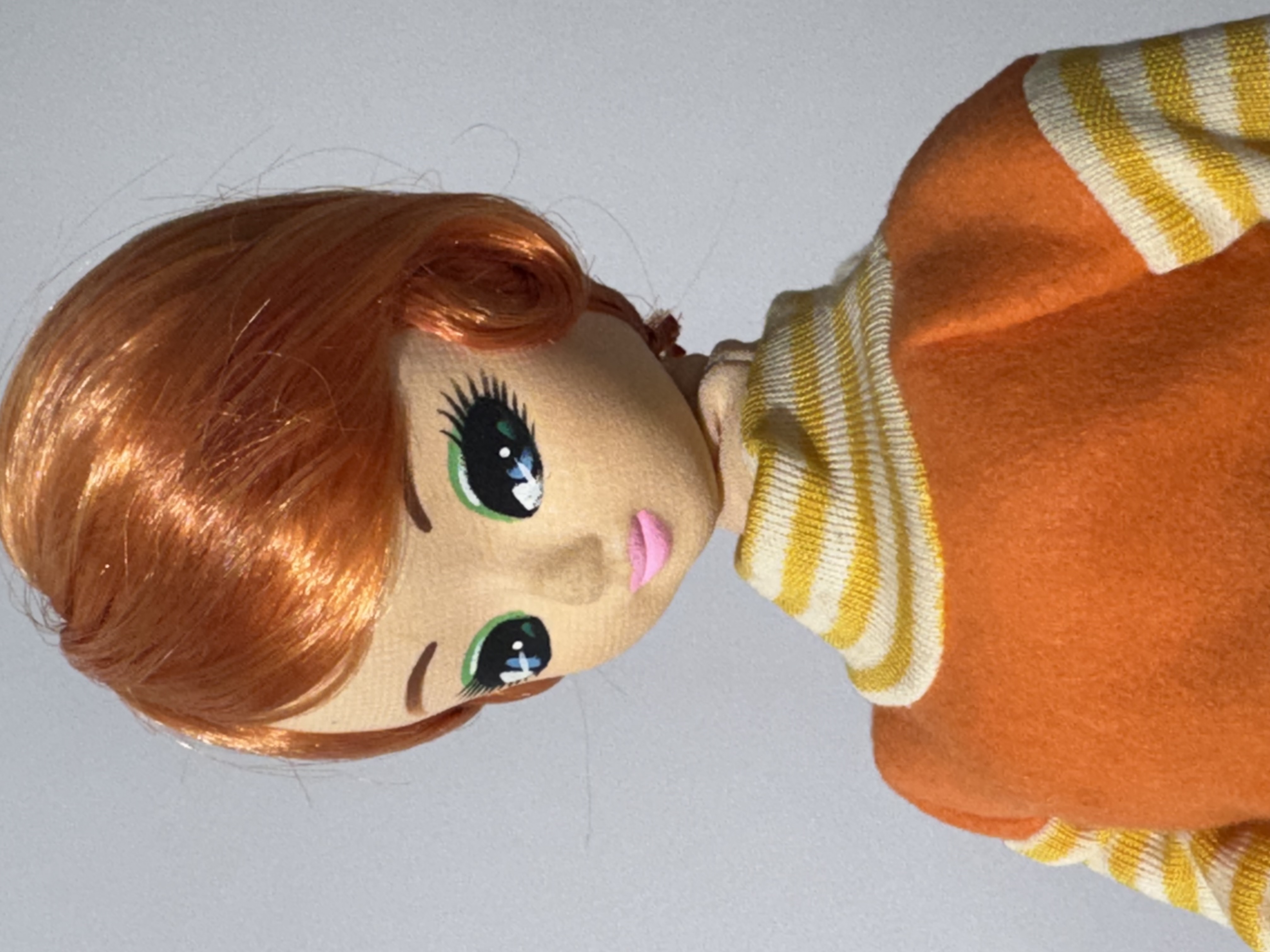 detail shot of 1960s doll with short, orange hair